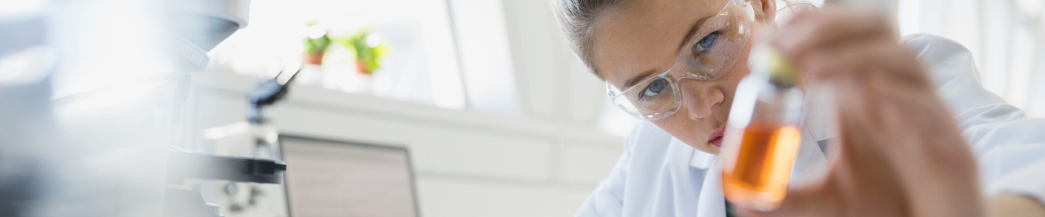 Nordmann Health Talk: Gesundheit von innen Woman in a lab holding a little bottle with orange fluid