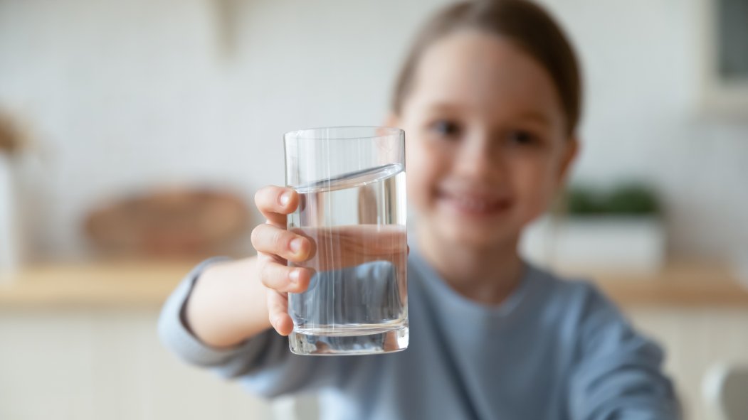 Girl holding a glass of water