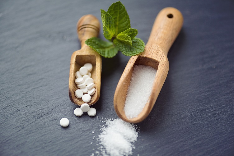 Sugar substitutes – Stevia, Erythritol and Xylitol in different forms shot on slate