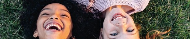 MIGHTY® POWDER PCEs from KAO Two Children lying on grass, smiling