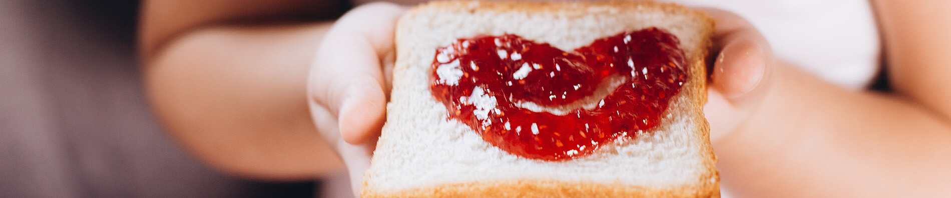 Food Talk Children hand's holding sandwich with jam