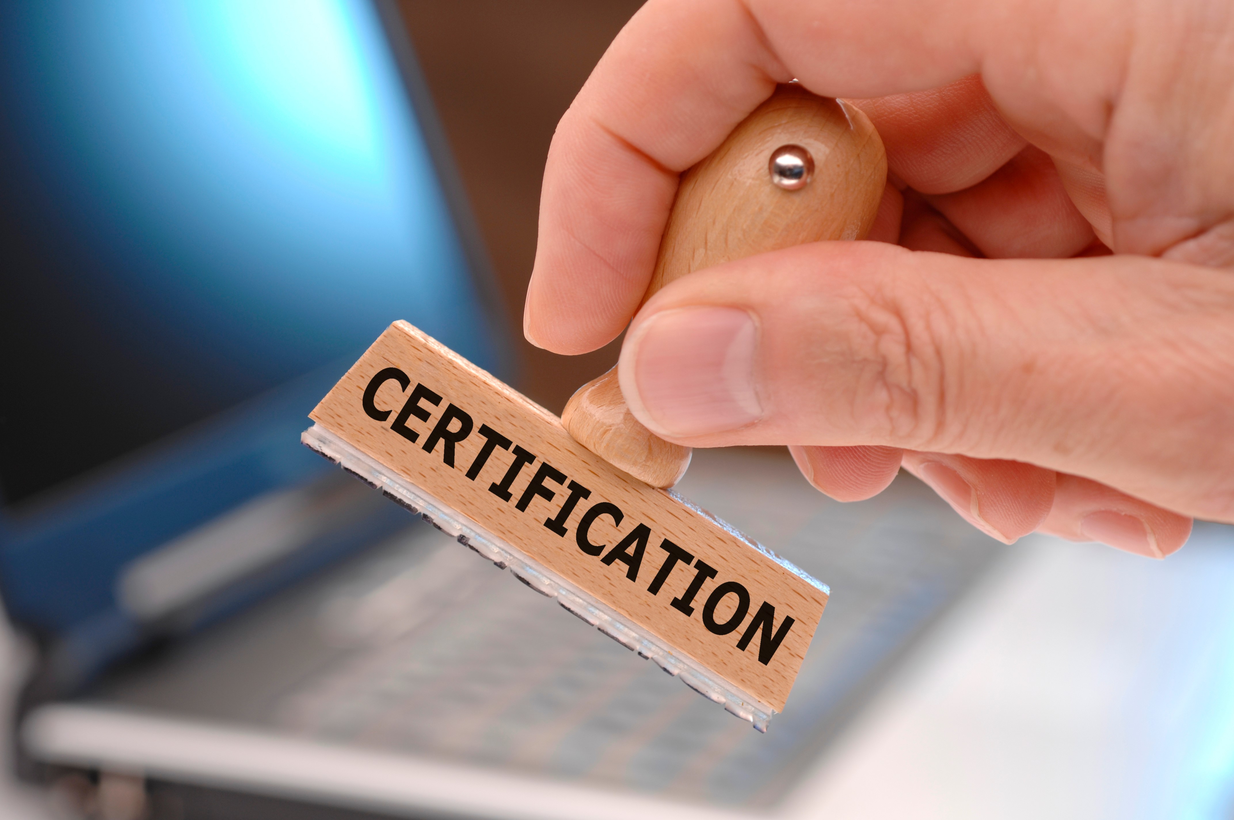 New partnership with Zukán a hand holding a stamp with the words ‘Certification
